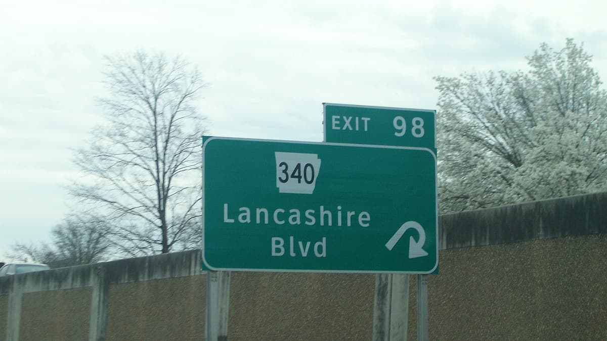 A roadside sign marking the junction of Arkansas Highway 340 with US Route 71, seen against open country