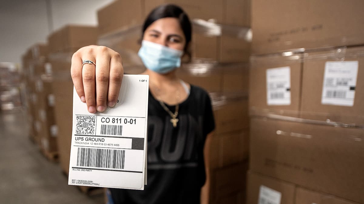 Professional Packaging Systems Quality Packaging (Qual Pac) Labeler Charon Lopez shows a sample label that will route food