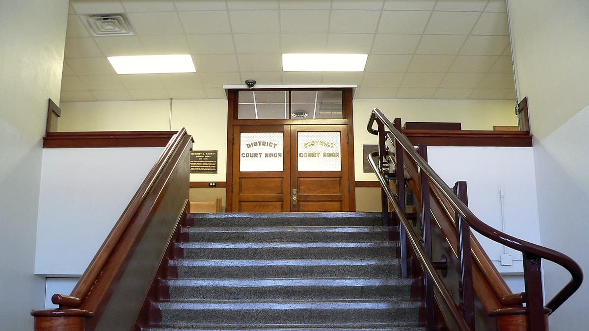 Interior stairs leading from entrance level to second floor of Knox County Courthouse in Center, Nebraska