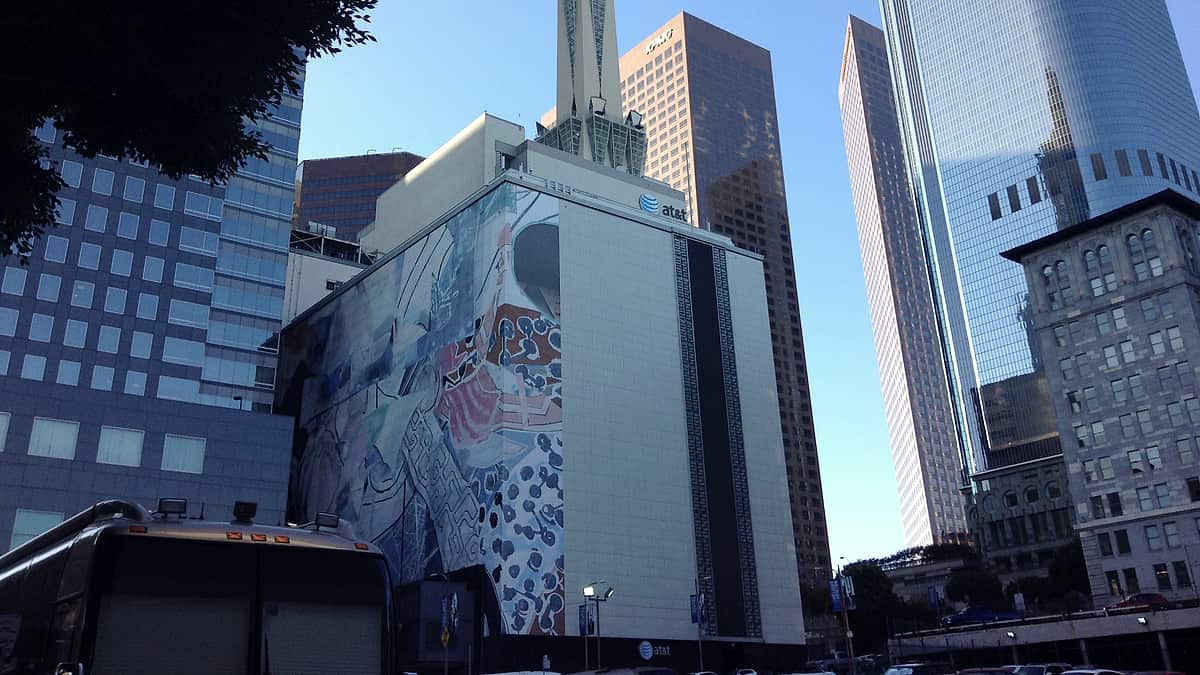 Office towers in downtown Los Angeles seen from street level, rising above the surrounding blocks